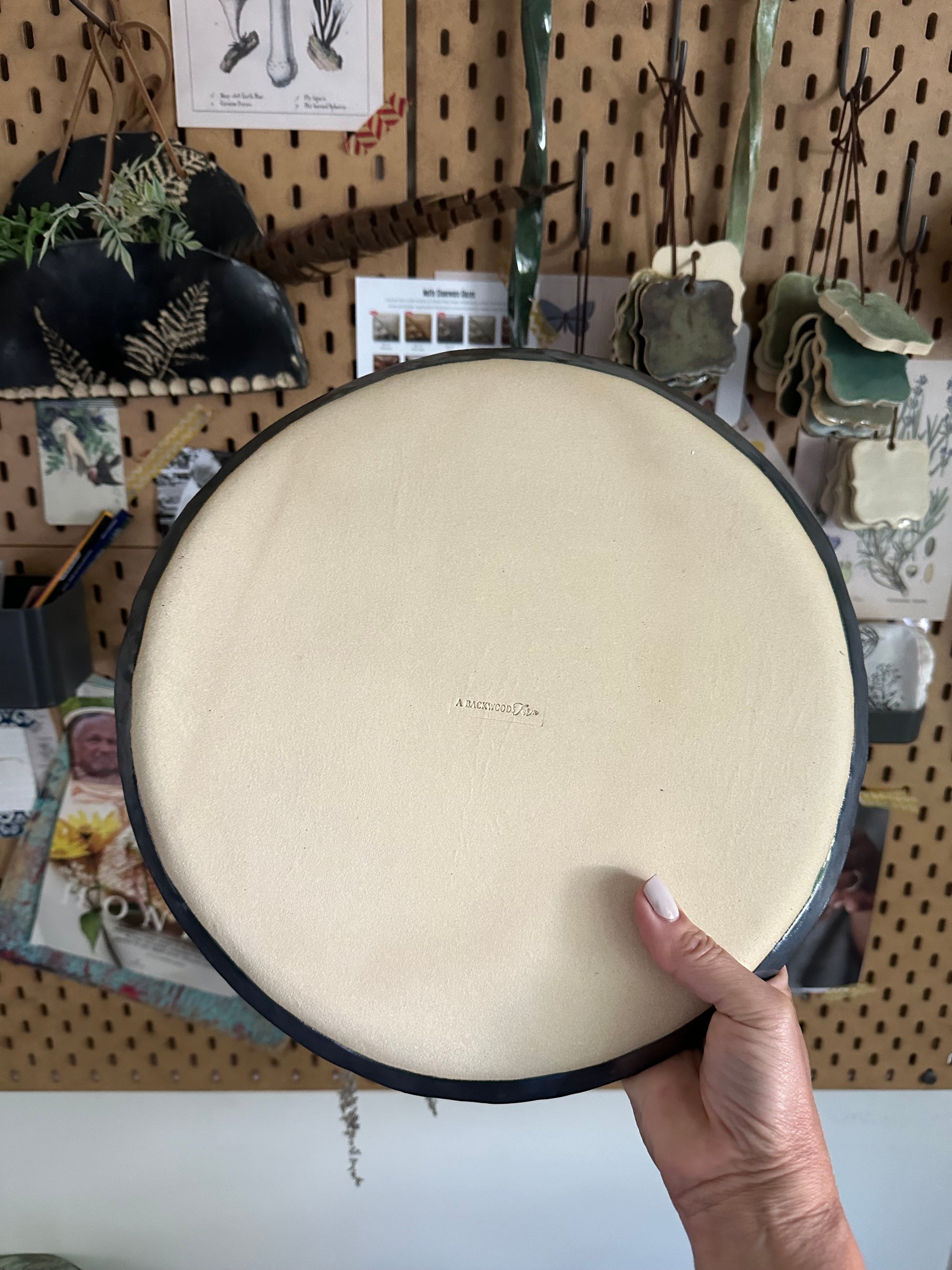 Back side of handmade pottery serving tray showing makers mark A Backwoodsfarm