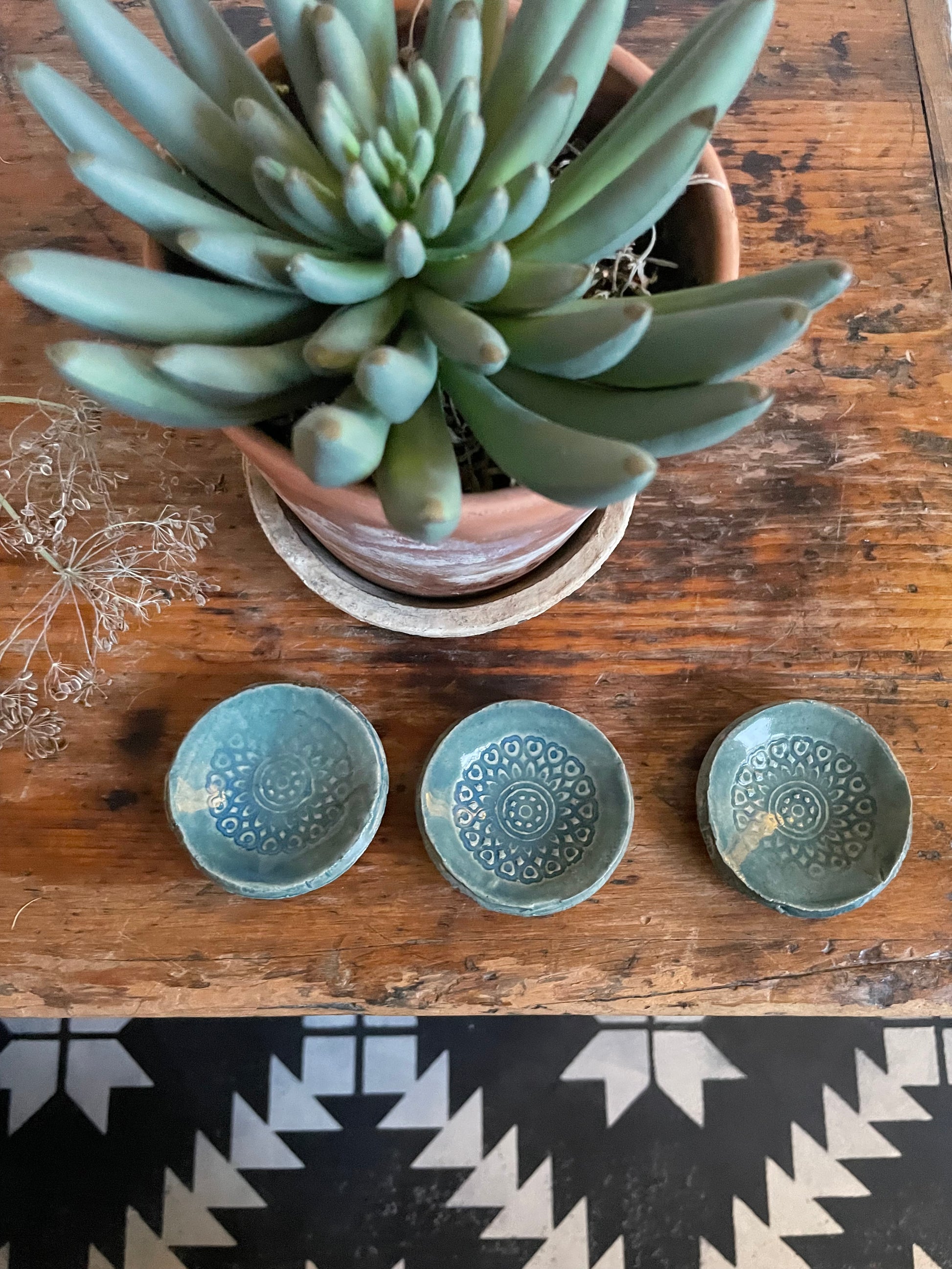 Three small trinket dishes with a boho pattern in a green glaze