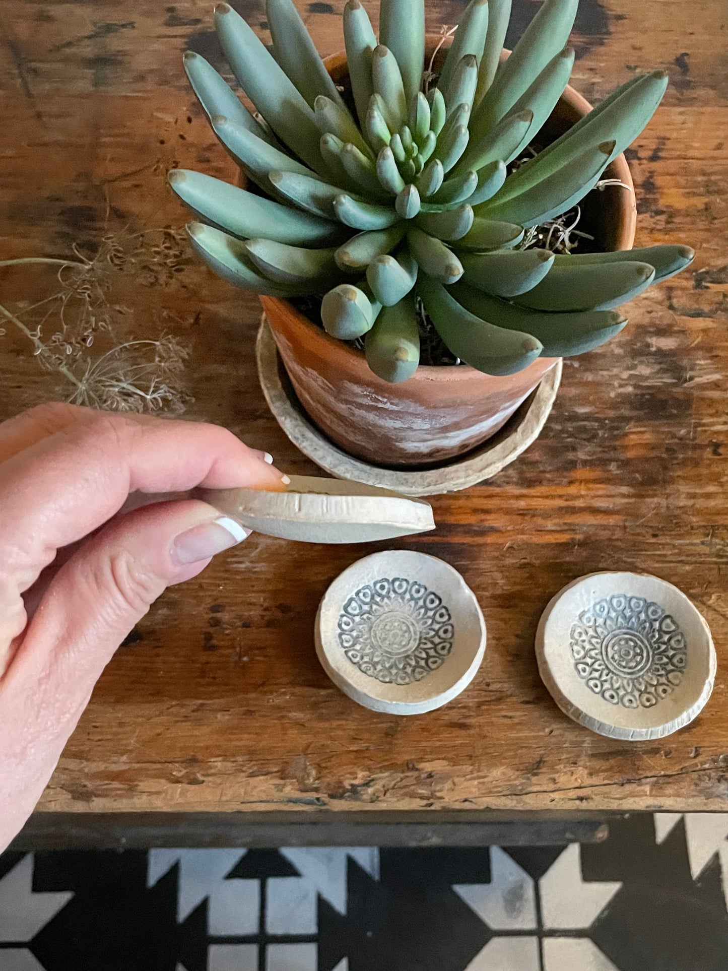 Three tiny dishes showing side of one.