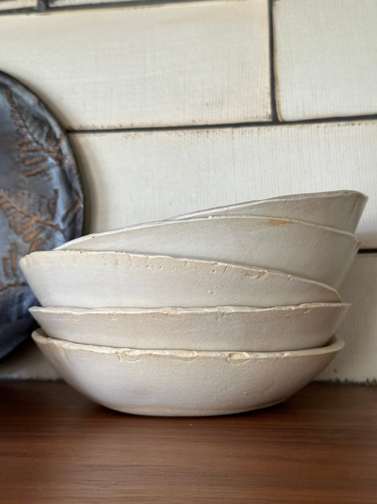 Stack of matte white pottery bowls